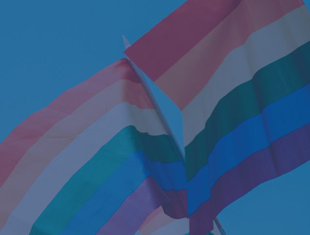 rainbow flag against blue sky