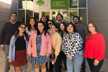 group of men and women posing in front of pacific oaks entrance