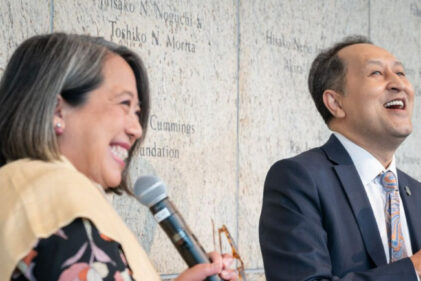 two people speaking into microphones