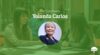 Professor Yolanda Carlos smiles in a portrait photo inset on a green banner image under text displaying her name.