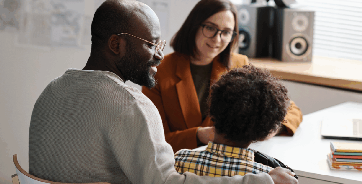 A woman and man talk to young boy