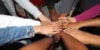 A circle of hands joined together.