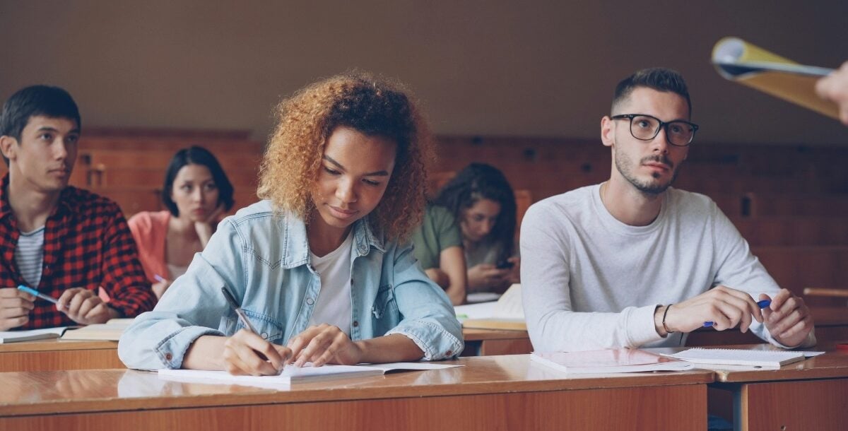 A male and female student in a lecture hall.