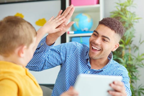 Teacher and student high fiving
