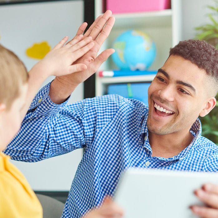 Teacher and student high fiving