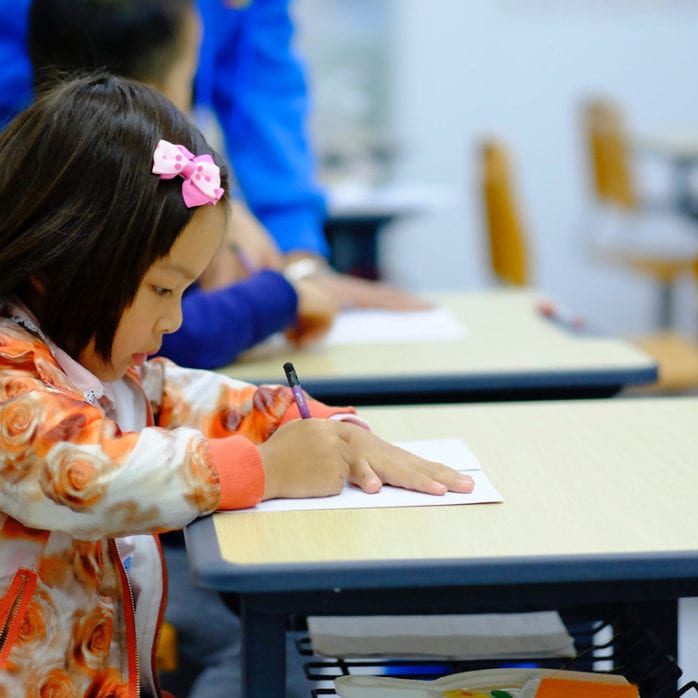 Child writing, guide to early childhood education terms
