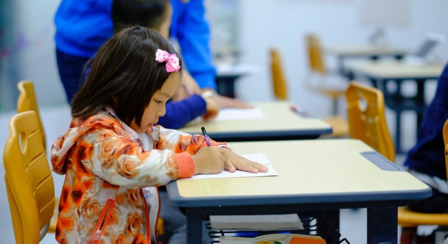 Child writing, guide to early childhood education terms