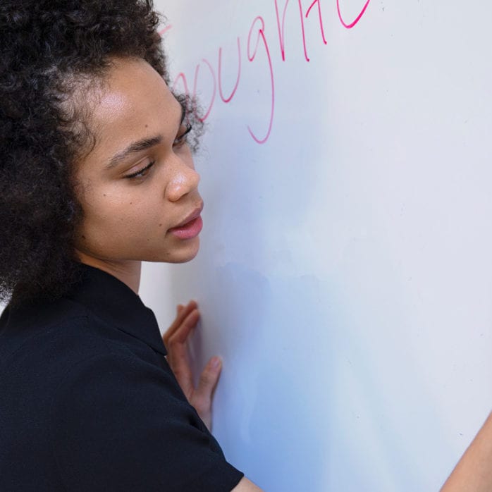 Woman writing on whiteboard