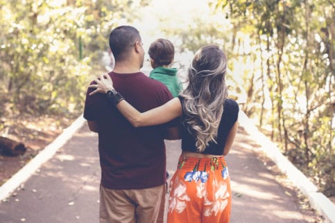 Three members of a family hugging