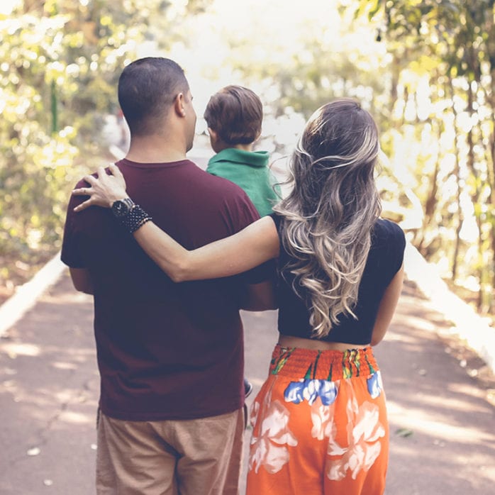 Three members of a family hugging