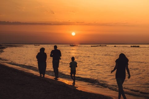 Family on the beach with sunset