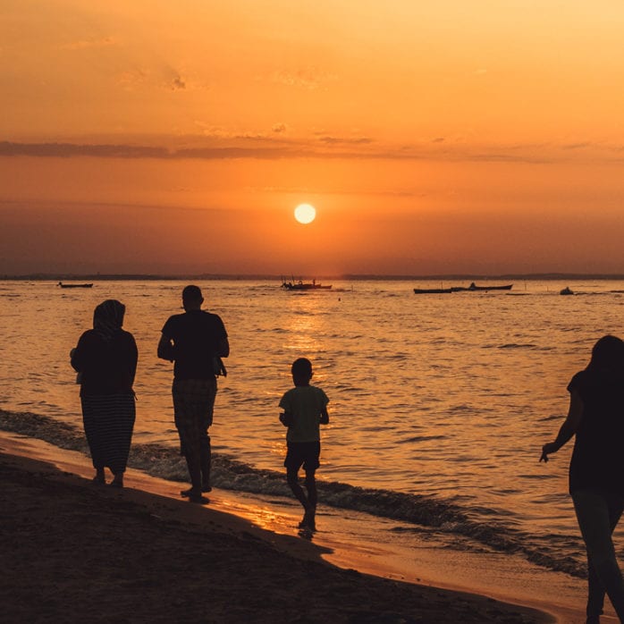Family on the beach with sunset