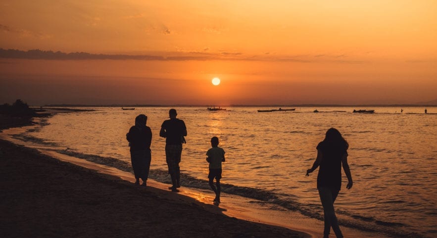 Family on the beach with sunset