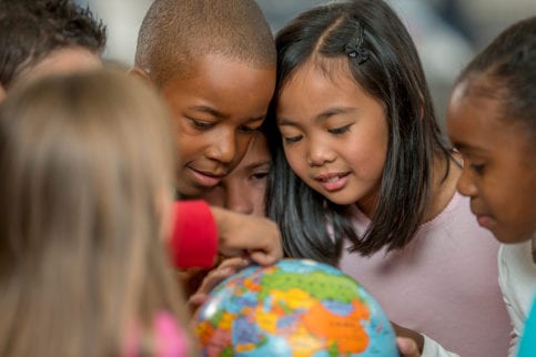 Children looking at globe