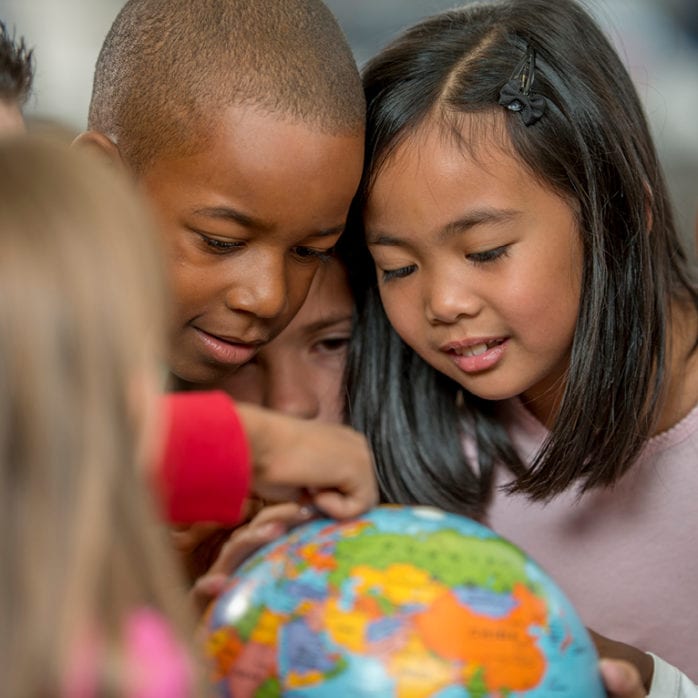 Children looking at globe