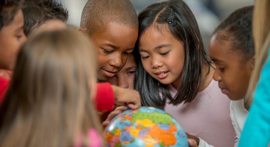 Children looking at globe