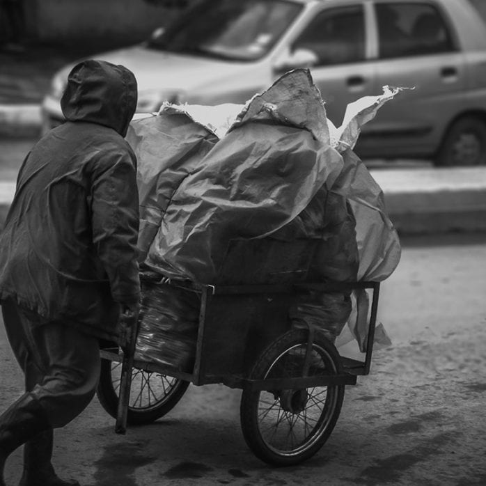 Homeless man with shopping cart