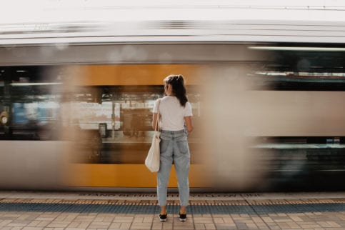 Women standing in front of moving train