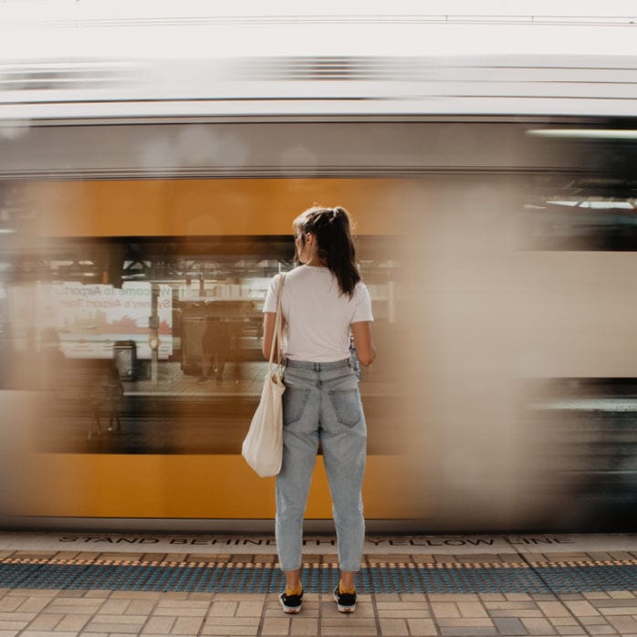 Women standing in front of moving train