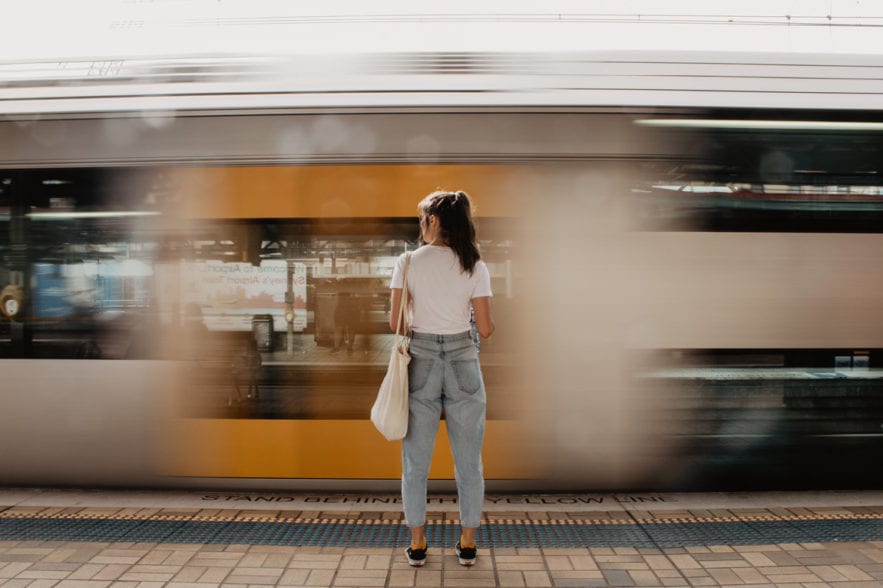 Women standing in front of moving train