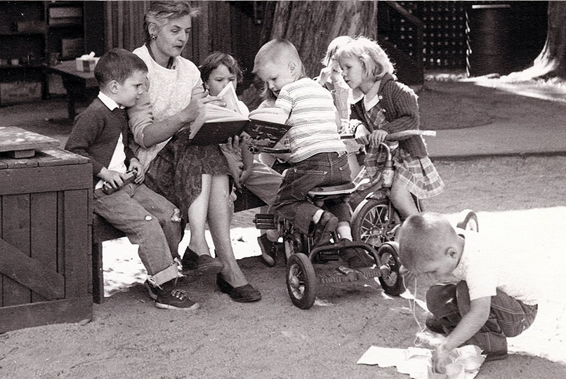 old photo woman reading to children