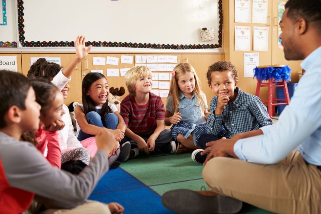 teacher sitting with children