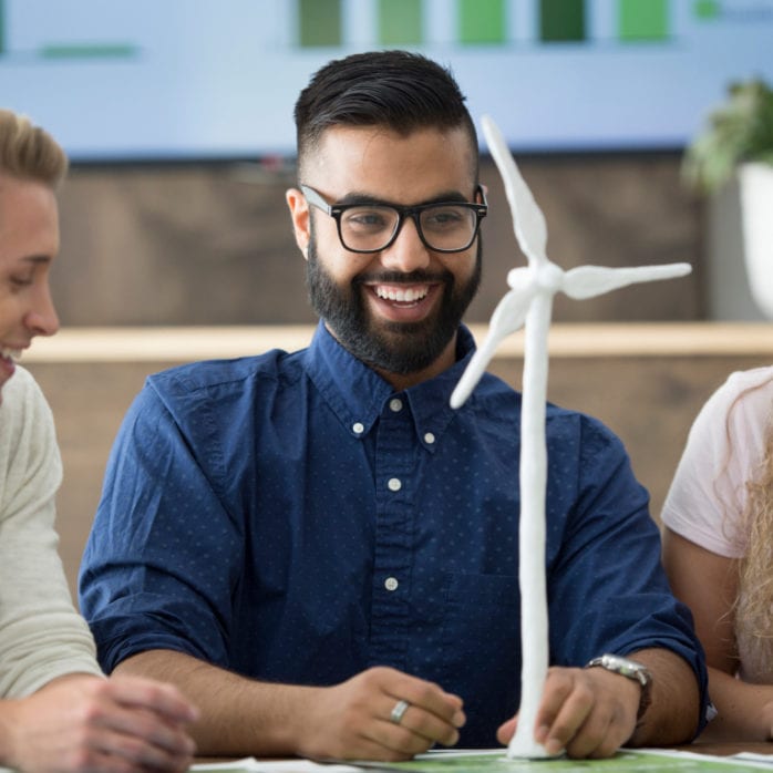 group of co-workers designing wind turbine