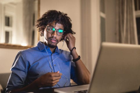 man at home at desk doing online learning