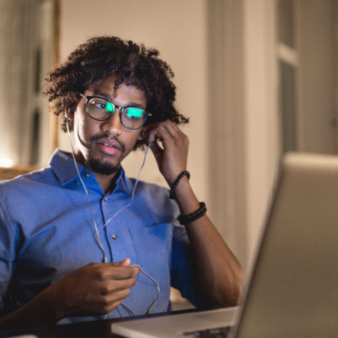 man at home at desk doing online learning