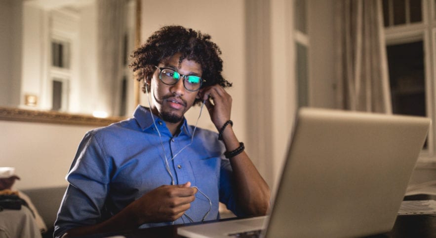 man at home at desk doing online learning
