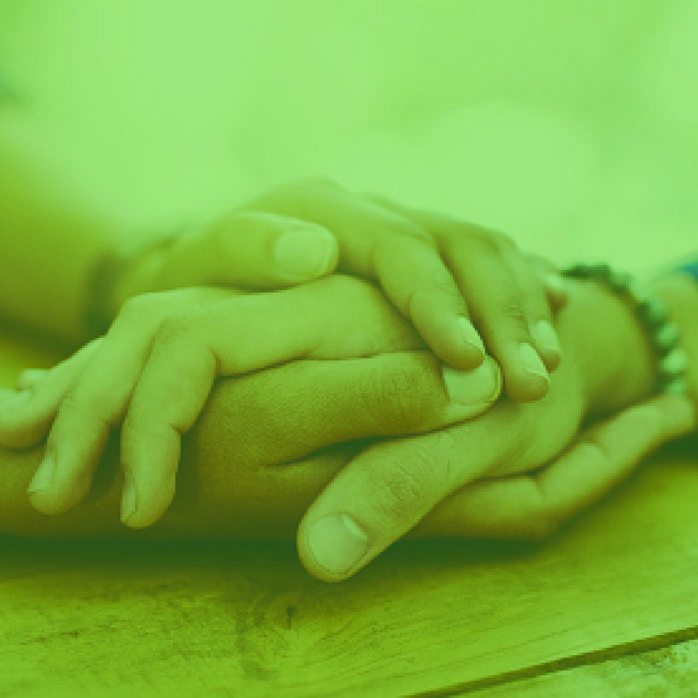 two sets of hands embracing