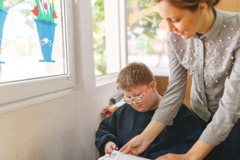 Special education teacher in the classroom with a student