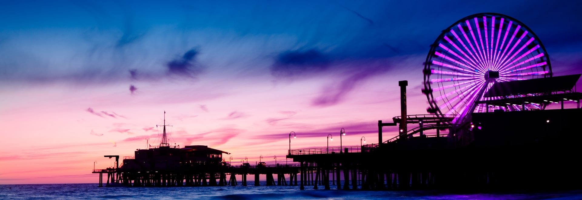 Sunset at a pier with ferris wheel