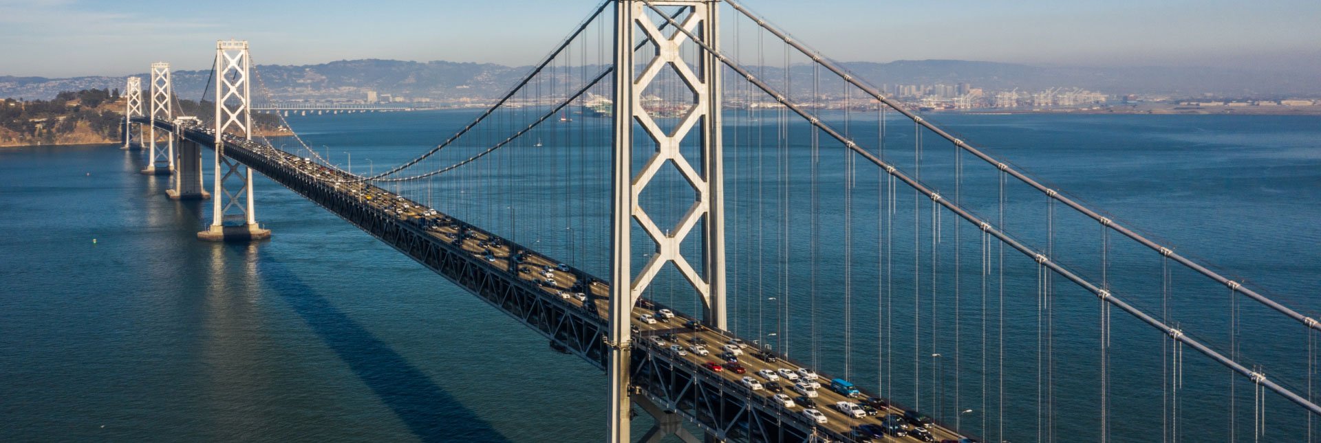 cars driving on a long suspension bridge